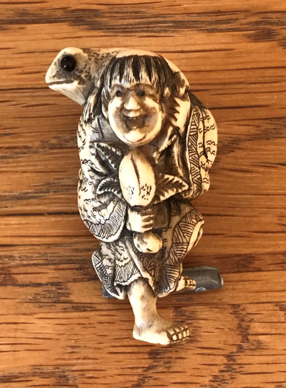 Netsuke man standing on one leg with toad on shoulder 1.jpeg